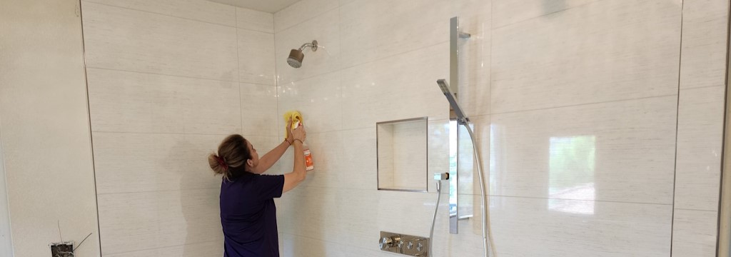 A picture of our staff  cleaning the bathroom